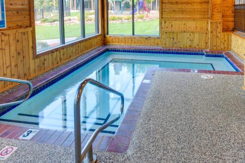 a swimming pool in a wooden house with at Cozy Alpine Escape Ski-InandOut at Lutsen Mtns in Lutsen