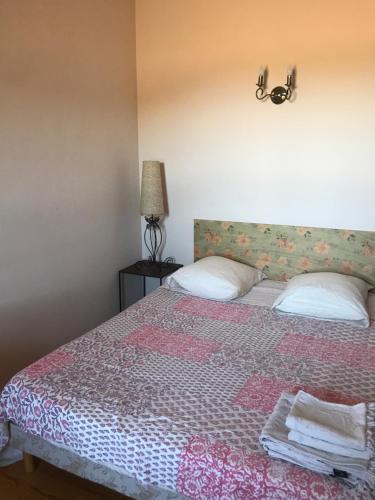 a bedroom with a bed with two pillows on it at A Loghja Di Cavallo Morto in Bonifacio