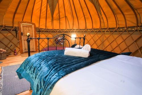 a bedroom with a bed in a yurt at Wye Glamping in Velindre