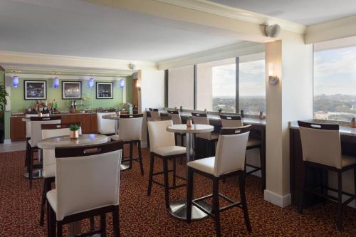a restaurant with tables and chairs and a bar at Marriott Tampa Westshore in Tampa