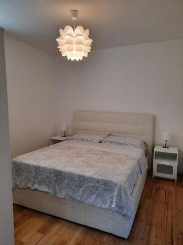 a bedroom with a bed and a chandelier at La Casetta Riviera Citra 008065-LT-0424 in Ventimiglia