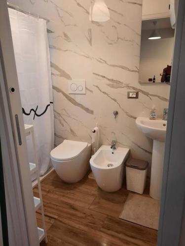 een badkamer met een wit toilet en een wastafel bij La Casetta Riviera Citra 008065-LT-0424 in Ventimiglia