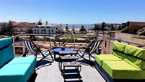 a balcony with chairs and a table on a roof at Riad Ocean Medina in Essaouira