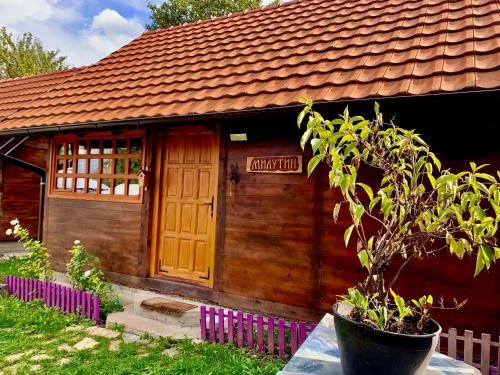 a small wooden house with a sign on it at Brvnare Mrkic in Kremna