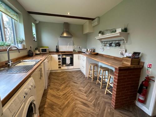 a kitchen with a counter and a sink and a counter top at West Cottage at Walnut Farm, Waxham, nr Sea Palling in Norwich