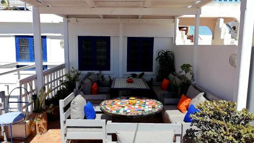 a patio with a table and chairs on a balcony at Riad Ocean Medina in Essaouira