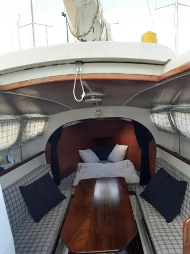 a bed and a table in the back of a boat at Vintage Sailboat in Belém in Lisbon