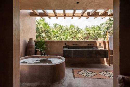 a bathroom with a tub and a sink at Xela in Tulum