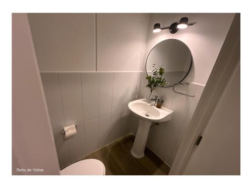 a bathroom with a sink and a mirror at Lovely and Peaceful Home in Guatemala