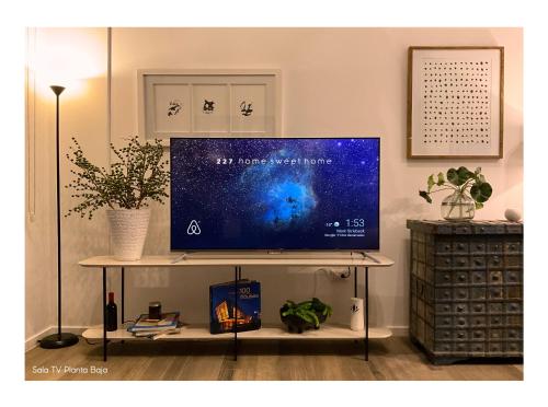 a flat screen tv on a stand in a living room at Lovely and Peaceful Home in Guatemala