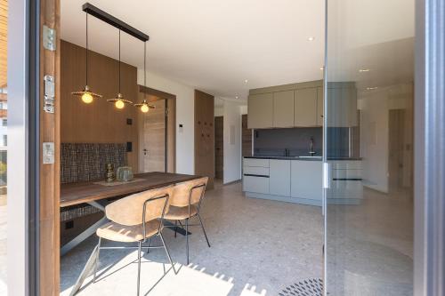 a kitchen with a table and chairs in a room at Fankhauser Apartments in Ried im Zillertal