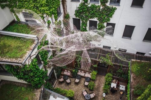 - une vue sur le jardin avec une toile d'araignée blanche dans l'établissement The Circus Hotel, à Berlin