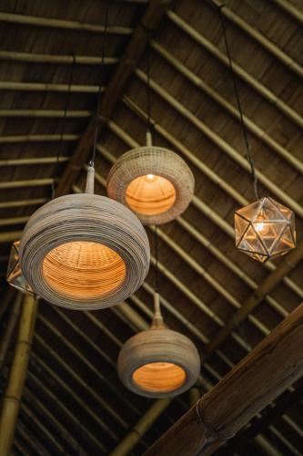 a group of lights hanging from a ceiling at Desa Eko in Munduk