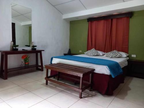 sypialnia z łóżkiem z czerwoną zasłoną w obiekcie Bosques del Tibet w mieście Cerro Verde
