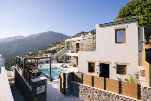 a view of a house with a swimming pool at Mirthea Suites in Mírthios