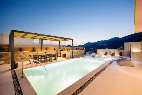 a swimming pool on the roof of a house at Mirthea Suites in Mírthios