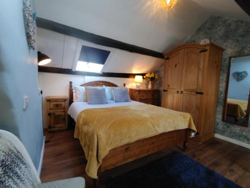 a bedroom with a large bed in a room at Darnholm Cottage in Robin Hood's Bay