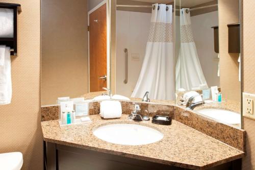 a bathroom with two sinks and a large mirror at SureStay Plus Hotel by Best Western Stevensville St Joseph in Stevensville