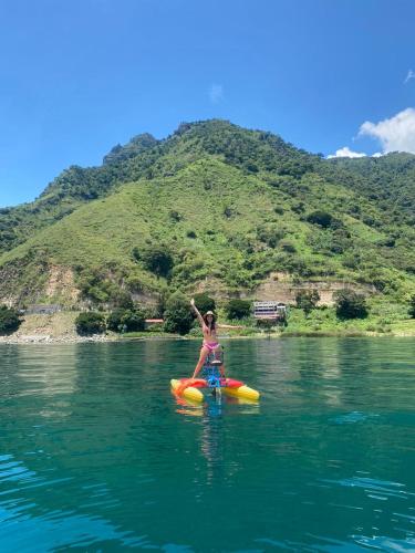 a woman is on a raft in the water at Mundo Abu San Juan La laguna in San Juan La Laguna