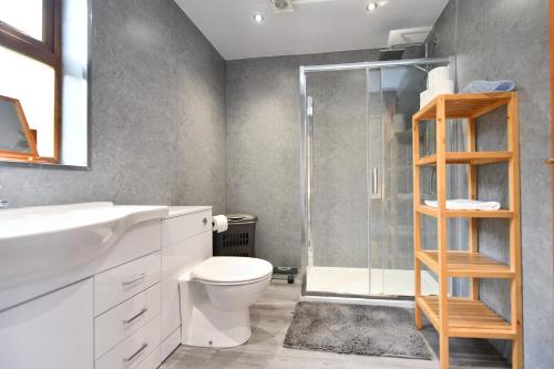 a bathroom with a shower and a toilet and a sink at North Blairkip Eildon in Sorn