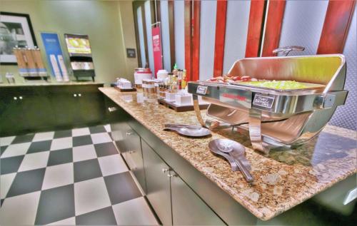 a counter top with a grill with food on it at Hampton Inn & Suites Flowery Branch in Flowery Branch