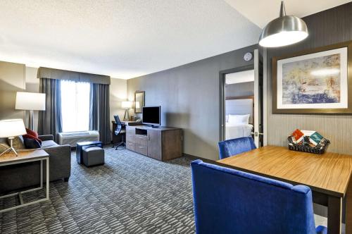a hotel room with a dining table and a living room at Homewood Suites by Hilton Hartford South-Glastonbury in Glastonbury
