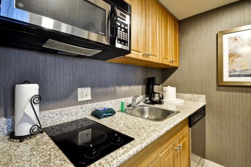 a kitchen with a sink and a microwave at Homewood Suites by Hilton Hartford South-Glastonbury in Glastonbury