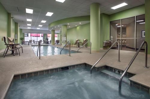 a hot tub in the middle of a large room with green walls at Hampton Inn & Suites Milwaukee Downtown in Milwaukee