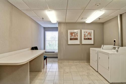 an office with a desk and a counter in a room at Homewood Suites by Hilton Leesburg in Leesburg