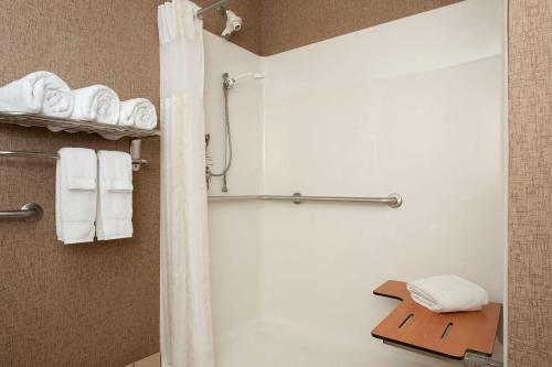 a bathroom with a shower with white towels at Hilton Garden Inn Columbus Edinburgh in Edinburgh