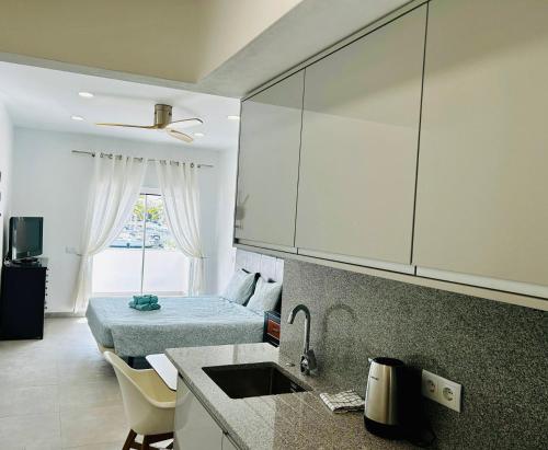a kitchen with a sink and a bed in a room at Marina view studio in Lagos town center sea view in Lagos