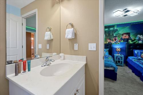 a bathroom with a sink and a mirror at Happy Planet II in Davenport
