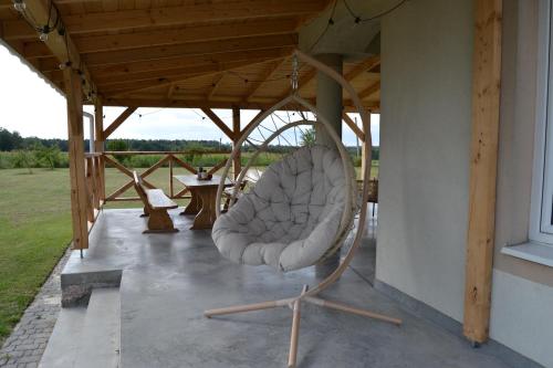 a chair sitting on a porch of a house at Domek mamy in Tykocin