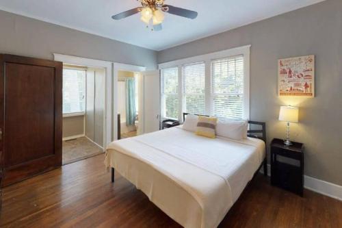 a bedroom with a large bed and a ceiling fan at Large Group Downtown Rental - Westend in Nashville