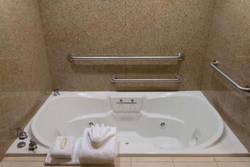 a large white tub in a bathroom with towels at Hilton Garden Inn Laramie in Laramie
