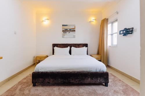 Ένα ή περισσότερα κρεβάτια σε δωμάτιο στο The Avery Apartments, Dzorwulu