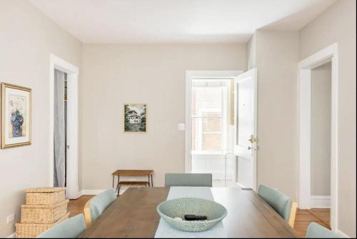 a dining room with a wooden table and chairs at Lovely Family Friendly Home- Free Parking in Evanston