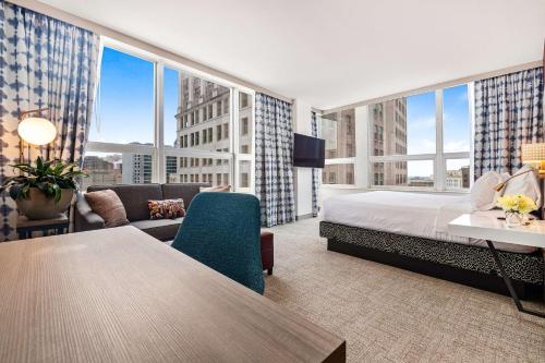 a hotel room with a bed and a large window at Hilton Garden Inn New Orleans French Quarter/CBD in New Orleans