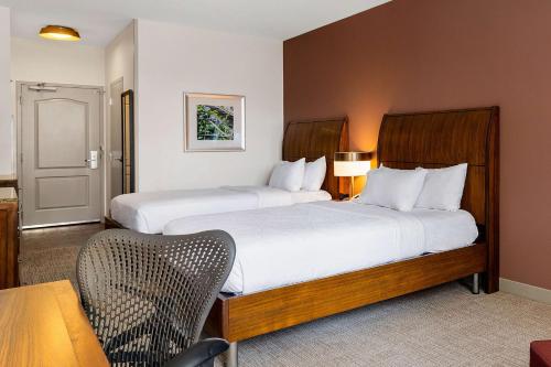a hotel room with two beds and a chair at Hilton Garden Inn New Orleans French Quarter/CBD in New Orleans