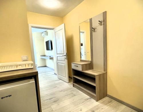a small room with a bathroom with a mirror at APART-HOTEL Stamopolu Lux с изглед към морето in Primorsko