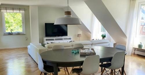 a living room with a table and a couch at Apartment Bella Vista in Glücksburg