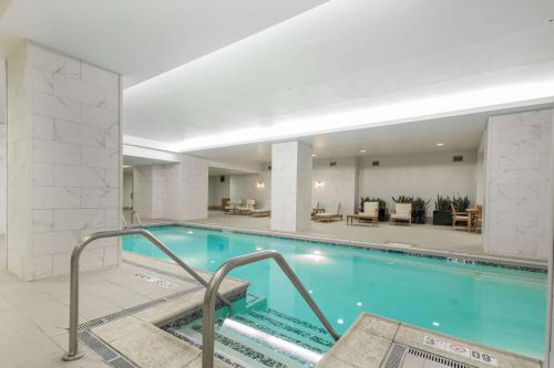 a swimming pool in a hotel lobby with a hotel at Embassy Suites Louisville Downtown in Louisville