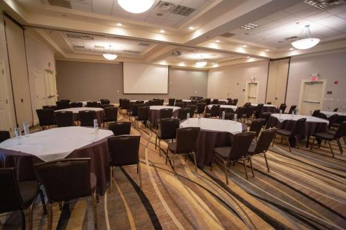 a conference room with tables and chairs and a whiteboard at Hilton Garden Inn Temple Medical Center in Temple