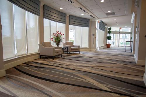 a lobby with chairs and windows in a building at Hilton Garden Inn Temple Medical Center in Temple