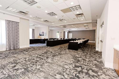 a large room with tables and chairs in it at Hilton Garden Inn Temple Medical Center in Temple