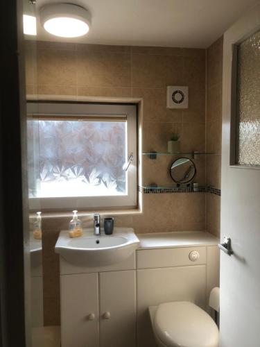 a bathroom with a sink and a window at Bellingham house 3 bedroom home in Brumby