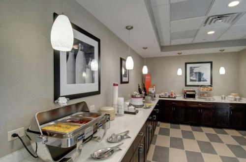 a large kitchen with a counter and a sink at Hampton Inn & Suites Springfield Downtown in Springfield