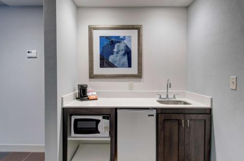 a kitchen with a sink and a microwave at Hampton Inn & Suites Springfield Downtown in Springfield