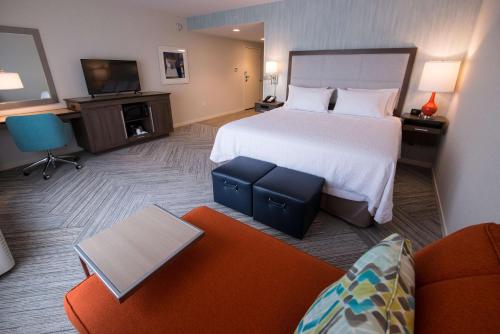 a hotel room with a bed and a couch at Chateau Fredericton, Trademark Collection by Wyndham in Fredericton
