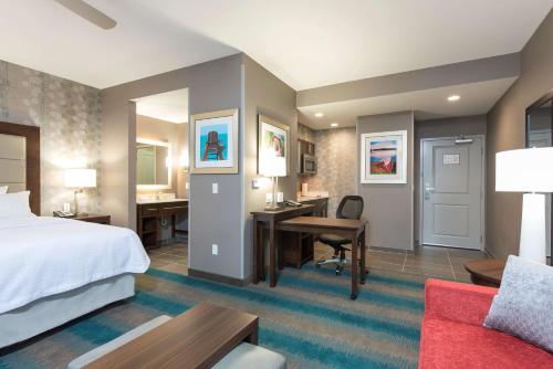 a hotel room with a bed and a desk at Homewood Suites by Hilton Cleveland/Sheffield in Avon